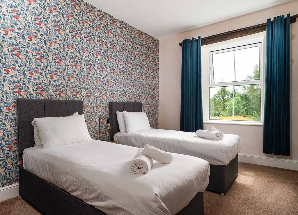 Elegant superior hotel room with crisp white linens, plush furnishings, and warm wooden accents at The Wheatsheaf Inn, reflecting refined countryside hospitality