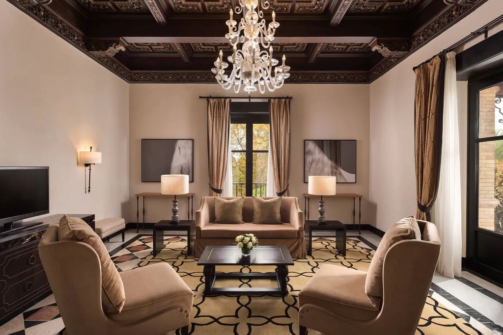 Five-star Hotel Alfonso XIII in Seville features ornate Moorish architecture with grand arched windows and elegant white facade adorned with tilework