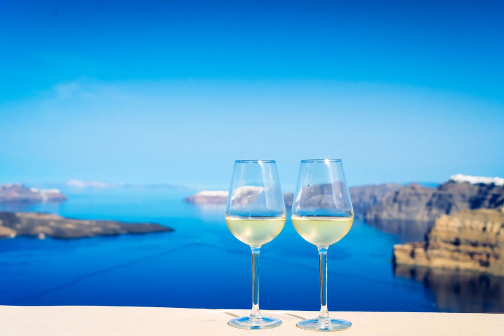 Ancient Greek archaeological site with sun-drenched marble ruins, pristine vineyards, and elegant wine glasses, showcasing a luxurious cultural exploration of scenset's archeology and wine tour.