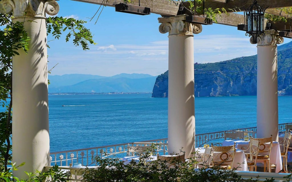 Luxurious clifftop hotel overlooking the azure waters of Sorrento, with elegant Mediterranean architecture and breathtaking Amalfi Coast panorama