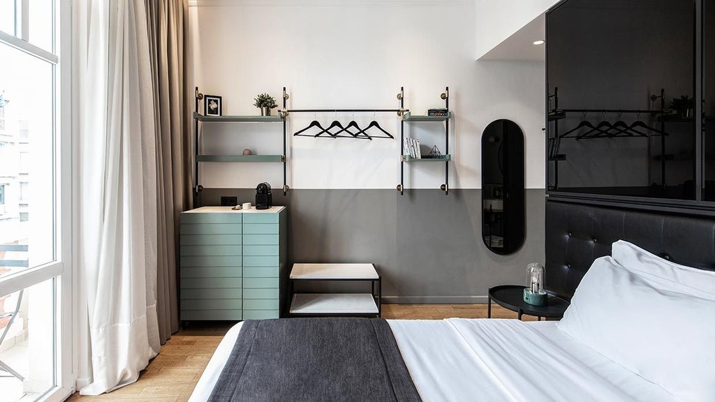 Minimalist hotel room with floor-to-ceiling windows, sleek modern furniture, neutral color palette, and stunning city view of Thessaloniki skyline