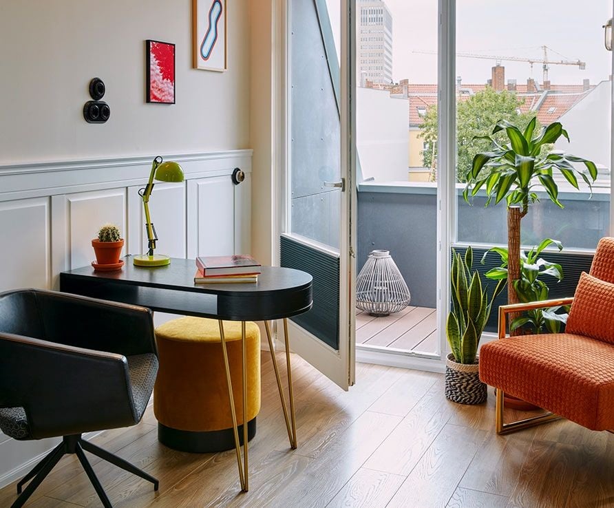 Elegant modern hotel lobby with sleek furniture, warm lighting, and minimalist design at a boutique hotel in Berlin's Ku'damm district.