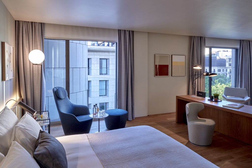 Minimalist luxe hotel room with warm wood tones, modern Barcelona design, plush king bed, city view window, and elegant neutral color palette