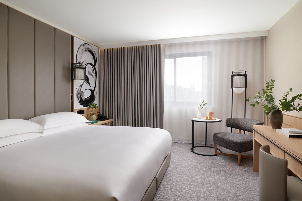 Modern, minimalist hotel room with elegant neutral color palette, featuring a plush king-sized bed, contemporary furnishings, and sleek city view at Nobu Hotel London Portman Square