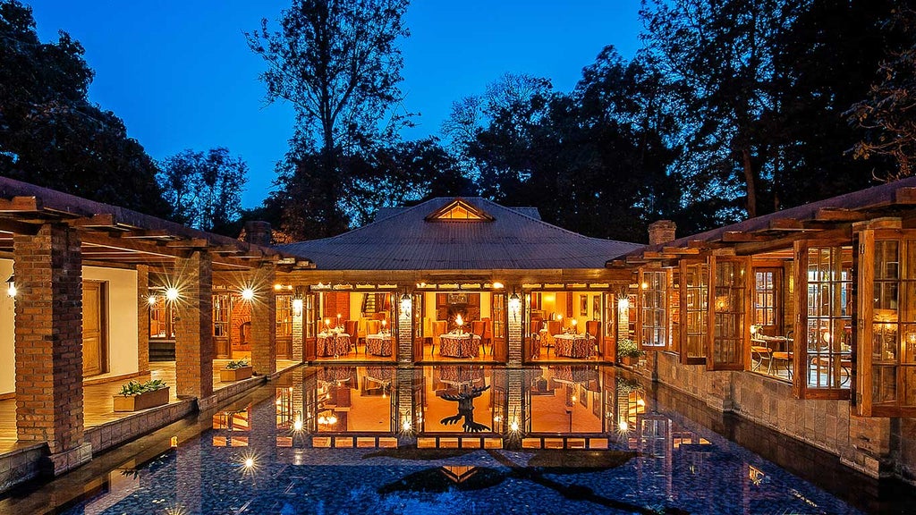 Elegant colonial-style lodge nestled among lush coffee plantations, featuring white-washed walls and red-tiled roofs at sunset