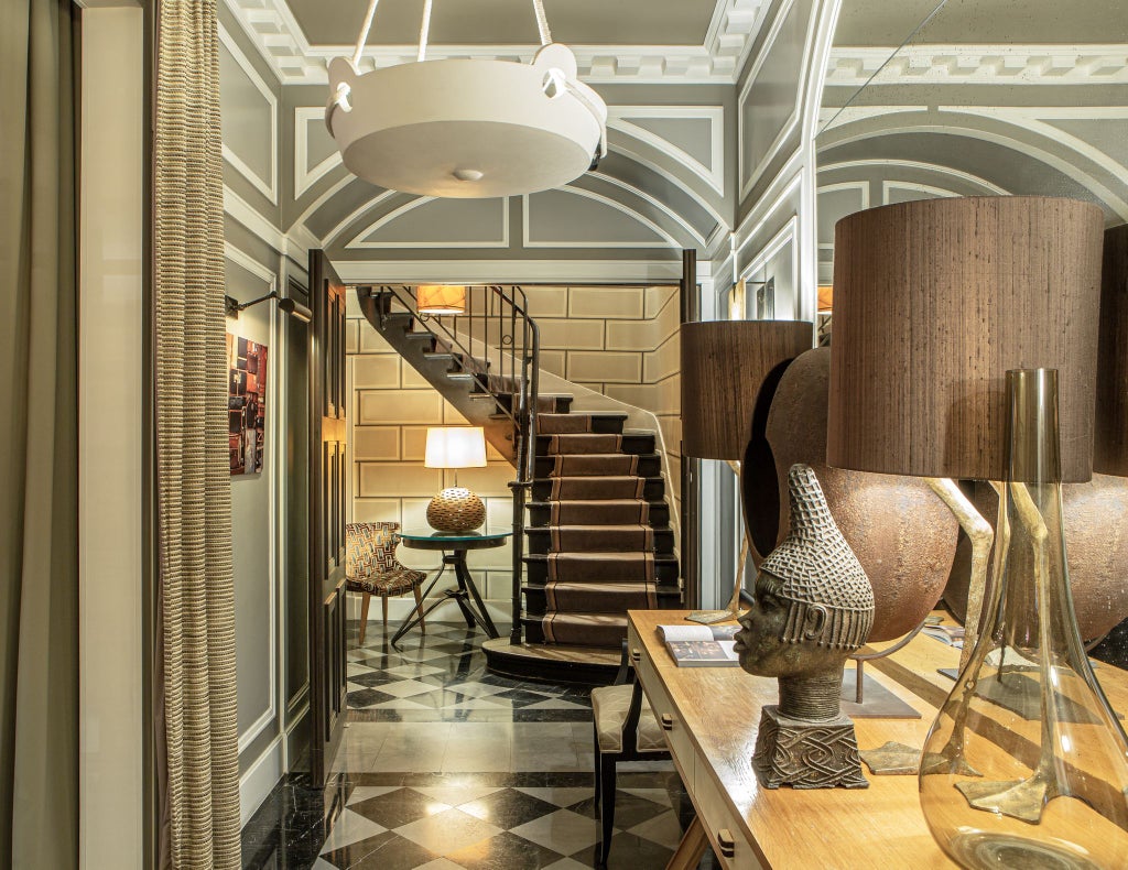 Elegant boutique hotel facade in Paris with classic French architecture, soft stone exterior, and charming balconies overlooking a tranquil Saint-Germain-des-Prés street