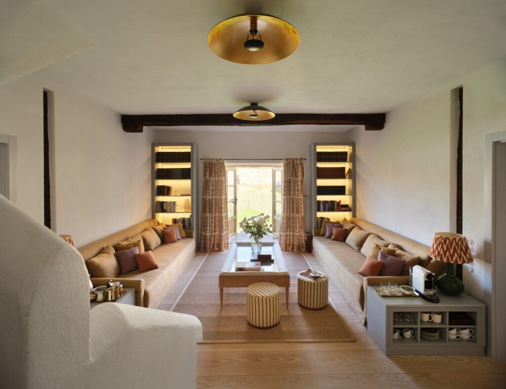 Luxurious corner barn suite at Bethlen Estates, featuring rustic wooden beams, elegant furnishings, and warm natural light in Transylvanian countryside setting