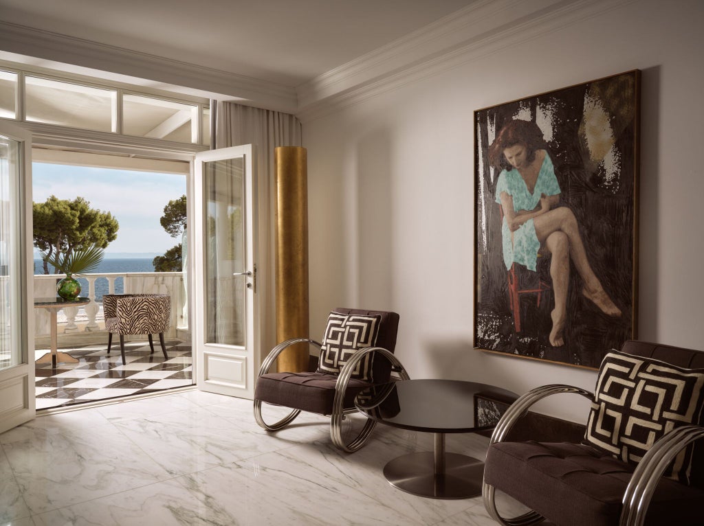 Luxurious Panorama Sea View Suite at coastal Greek resort, featuring elegant décor, expansive ocean vista, and modern minimalist design with natural lighting