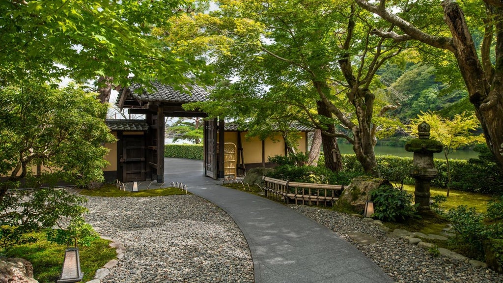 Luxurious traditional Japanese ryokan-style hotel nestled along Kyoto's Arashiyama river, featuring elegant wooden architecture and serene natural surroundings