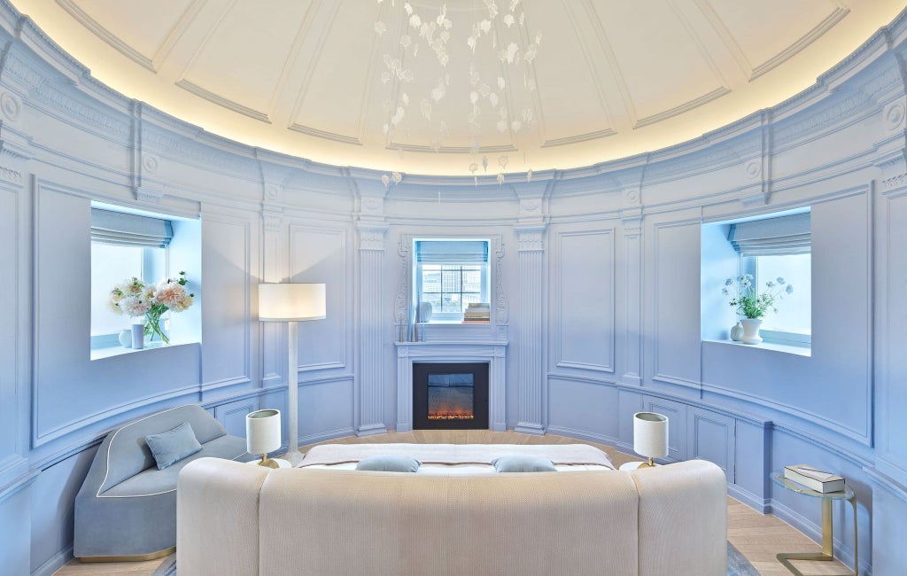 Luxurious hotel suite at One Aldwych with elegant dome ceiling, modern furnishings, neutral color palette, and sophisticated urban design aesthetic