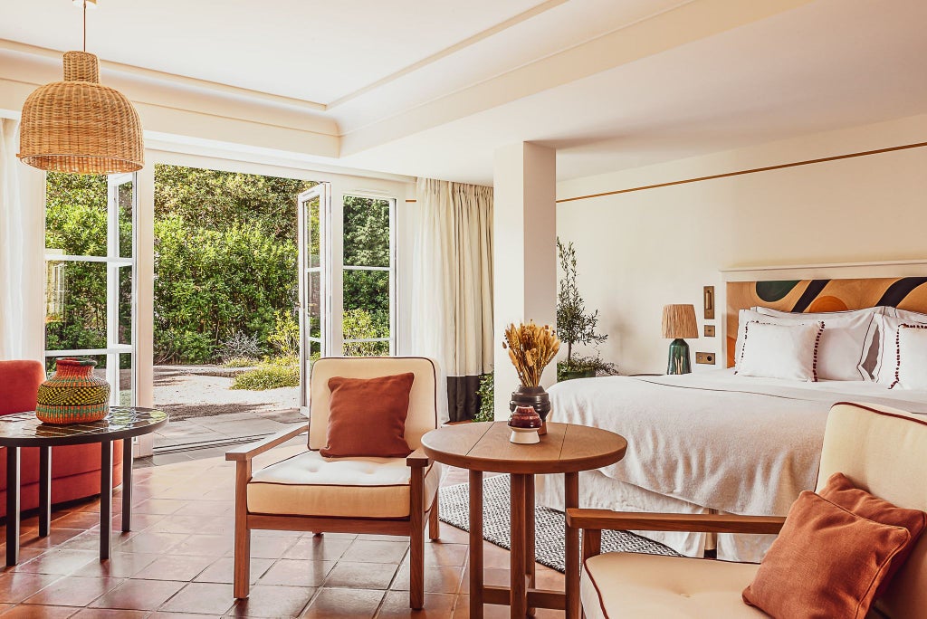 Elegant prestige junior suite at Lou Pinet hotel with soft neutral tones, plush bedding, designer furnishings, and subtle French Riviera charm in Saint-Tropez