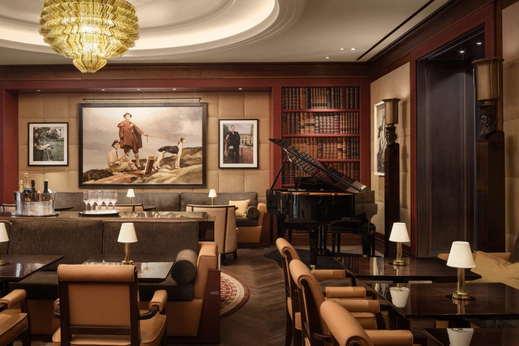 Elegant marble lobby of luxury hotel in Mayfair, London, with sparkling chandeliers, plush seating, and sophisticated Art Deco-inspired interior design