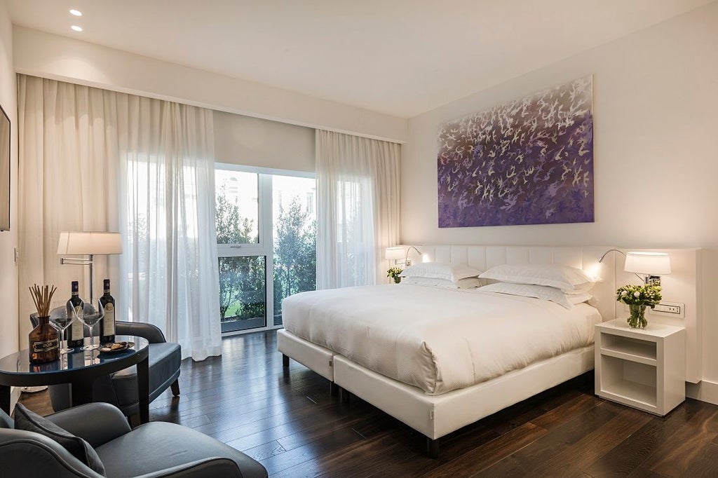 Luxurious junior premium hotel room at Magna Pars L'Hotel à Parfum, featuring elegant design, soft neutral tones, and sophisticated Italian minimalist decor