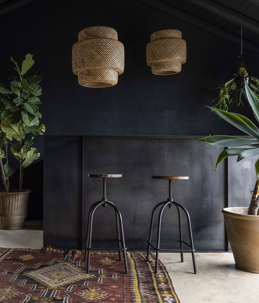 Luxurious black-themed hotel suite with minimalist design, featuring elegant dark furnishings and dramatic architectural elements in an Italian palazzo setting