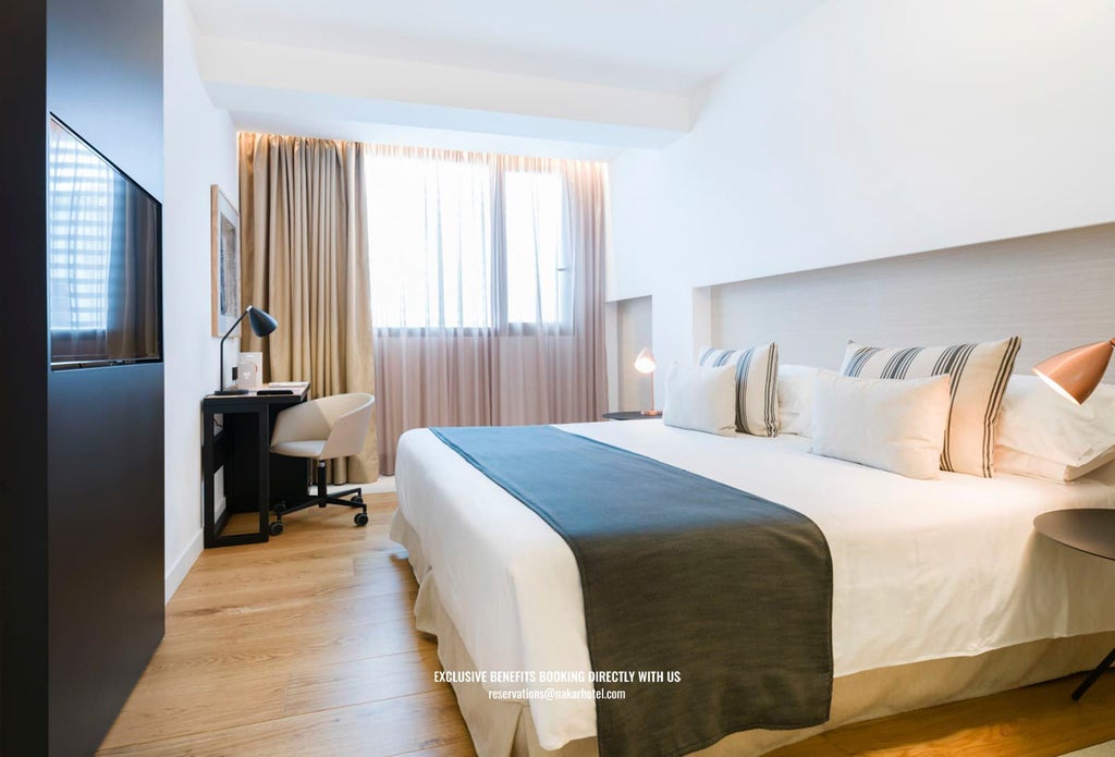 Modern luxury hotel room with crisp white linens, minimalist design, large windows overlooking urban scenset, and elegant neutral color palette with sleek contemporary furnishings.