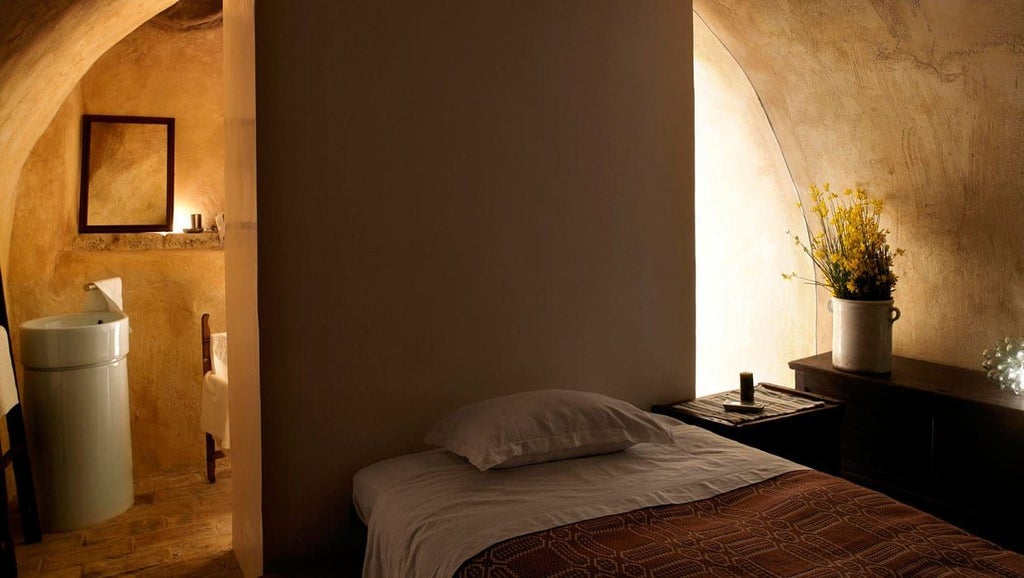 Rustic stone hallway of Sextantio Albergo Diffuso, warm lighting illuminating ancient architectural details of traditional Italian mountain village hotel