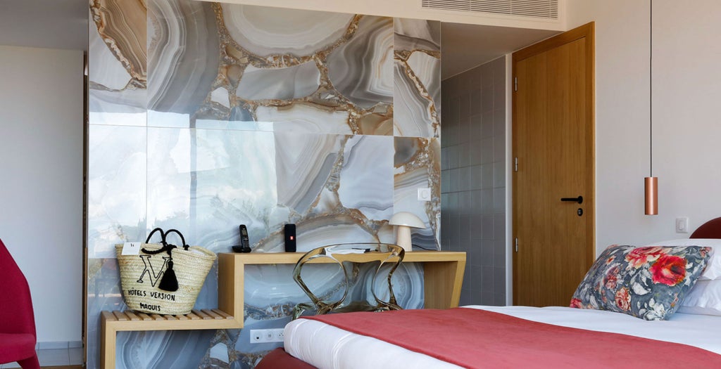 Contemporary hotel room with panoramic citadel views, featuring elegant decor, king bed with crisp linens and dramatic wall-mounted headboard