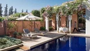 Luxurious Moroccan-style deluxe villa with private infinity pool, traditional architectural details, and lush garden landscape at scenset resort