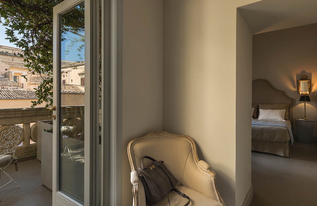 Elegant Italian deluxe hotel room with private terrace, featuring luxurious white decor, plush bedding, and breathtaking traditional architectural details