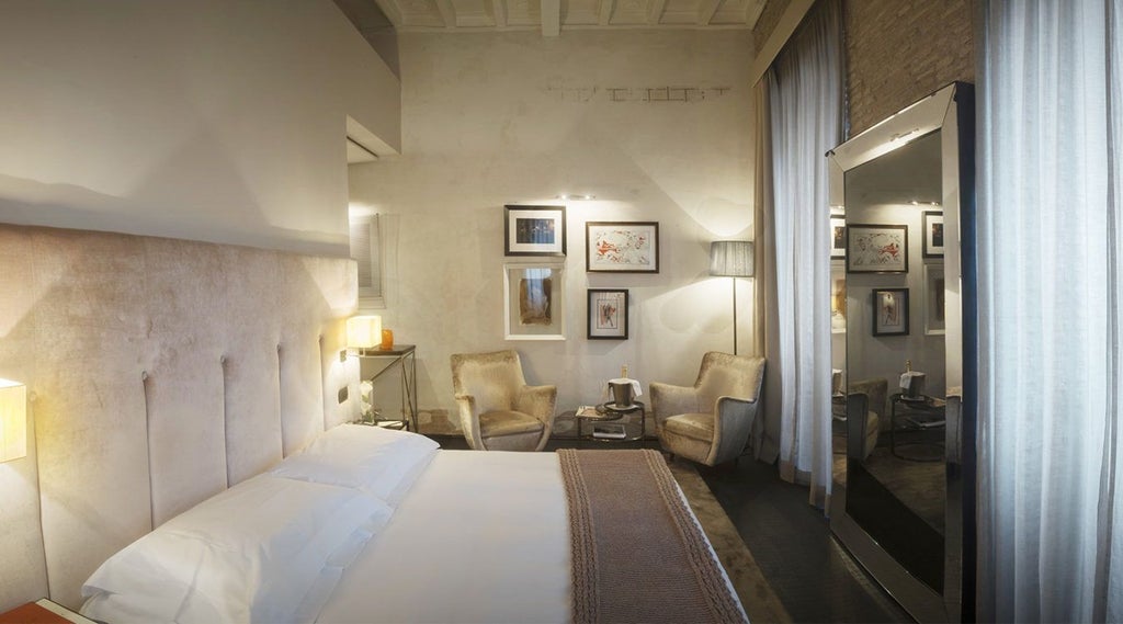 Elegant marble-clad junior suite with panoramic city view, luxurious king bed, soft neutral tones, and minimalist Italian design aesthetic from D.O.M Hotel