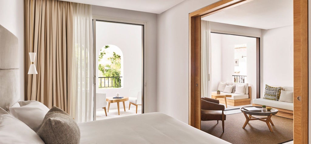 Luxurious Nobu Hotel Marbella Deluxe Suite overlooking Plaza, featuring modern minimalist design with elegant white furnishings and expansive natural light