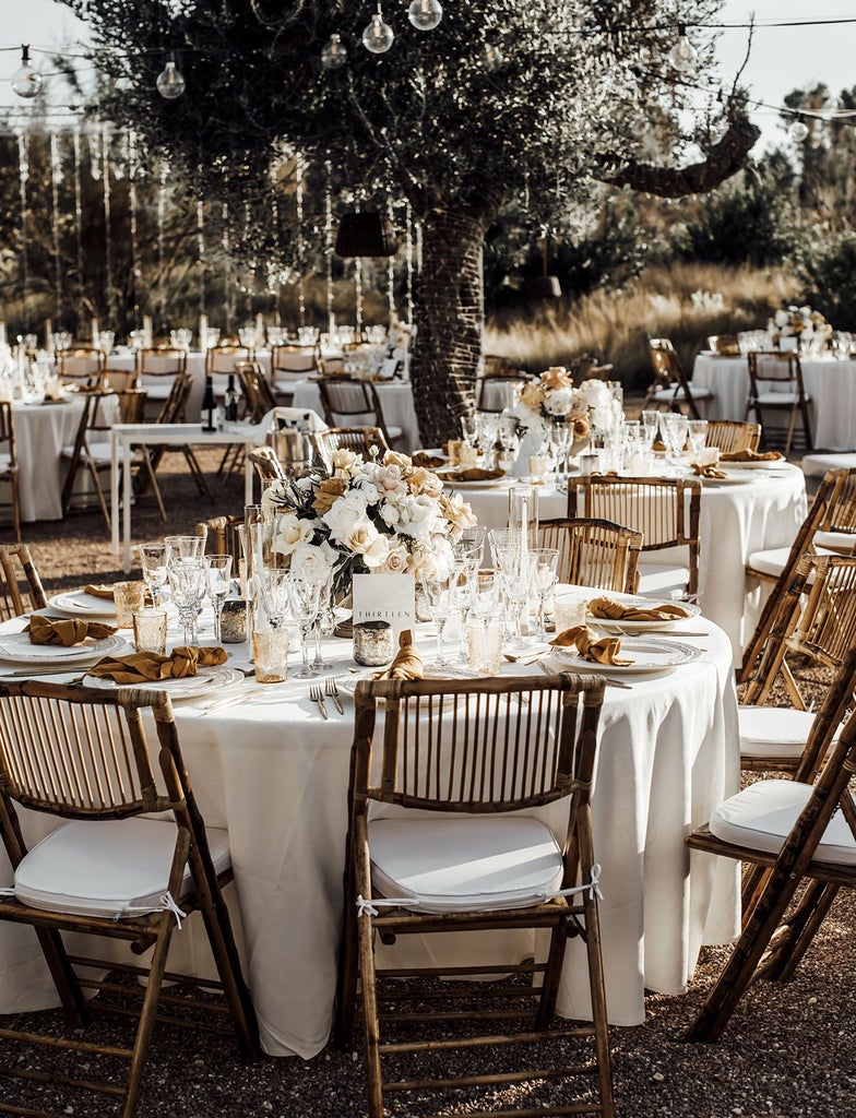 Luxurious Mediterranean stone hotel with white-washed walls, elegant courtyard, and minimalist design nestled in scenic rural landscape of scenset