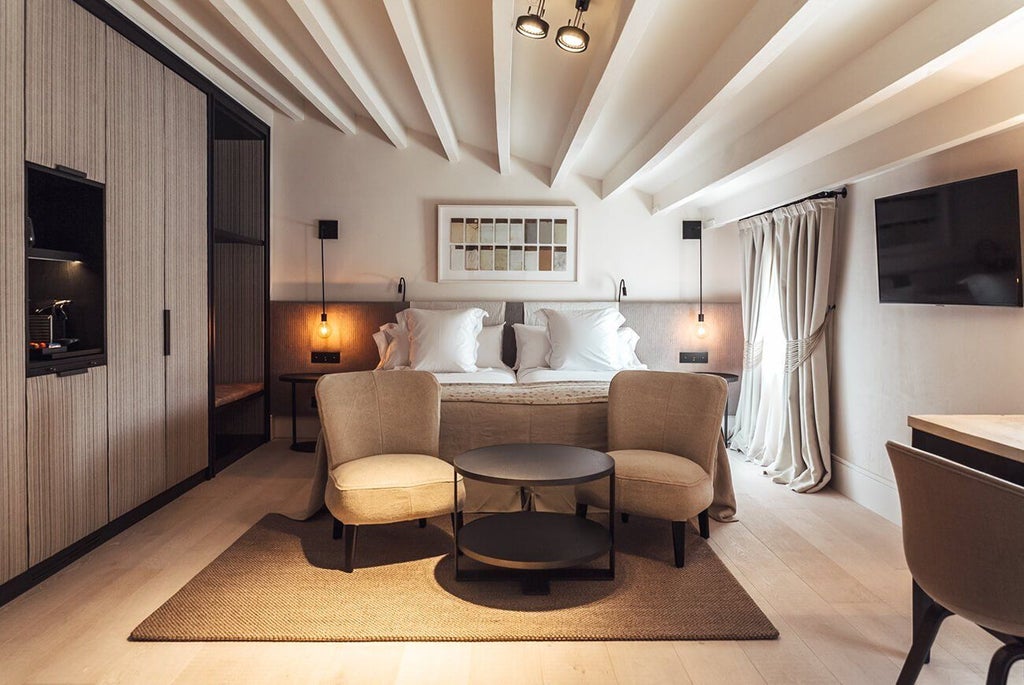 Elegant Privilege Room at Sant Francesc Hotel Singular, featuring minimalist design, warm wood tones, and luxurious modern furnishings in a spacious Spanish interior