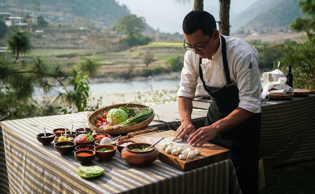 Luxurious mountain lodge nestled in Bhutanese hills, featuring traditional architecture, terraced gardens, and misty valley views