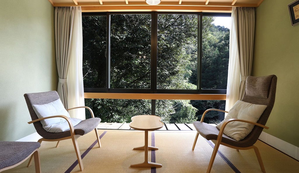 Minimalist Japanese suite with wooden accents, sliding shoji screens, elegant tatami flooring, and a modern rainfall shower with traditional aesthetic.