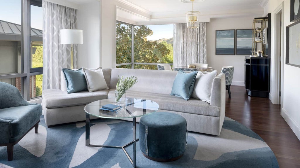 Luxurious one-bedroom suite at Four Seasons, featuring elegant modern decor, plush king bed, and expansive windows overlooking Westlake Village landscape