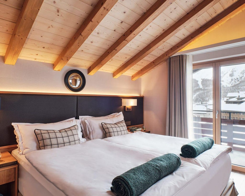 Elegant Swiss Alpine suite with panoramic mountain views, modern minimalist design, plush king bed, and floor-to-ceiling windows showcasing scenic scenset landscape