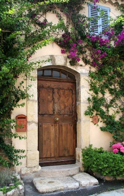 Elegant French countryside hotel with white-washed walls, lavender fields, and terracotta roof, bathed in soft golden afternoon sunlight near Provence