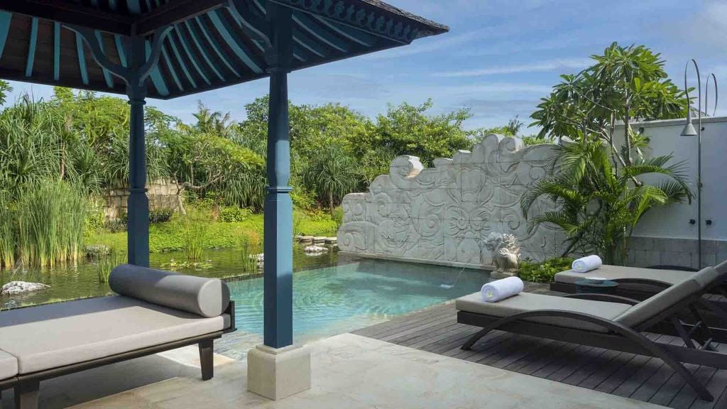 Two elegant connecting villas with private pools, tropical landscaping, and panoramic ocean views from Jumeirah Bali's beachfront location