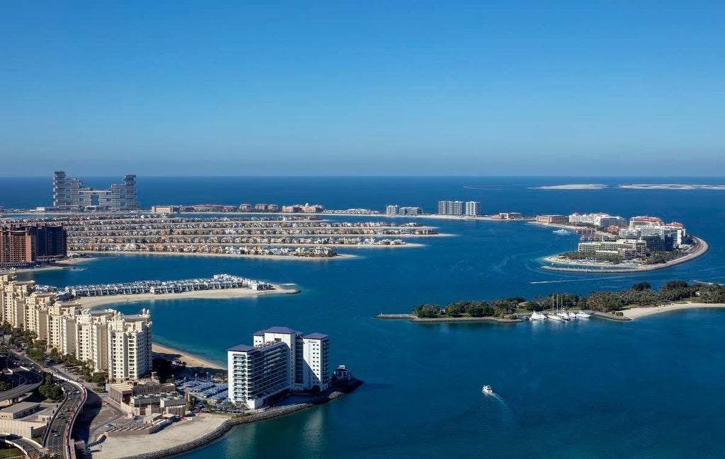 Modern luxury hotel exterior with sleek architecture, palm trees, and Dubai's urban skyline, showcasing contemporary Middle Eastern hospitality design