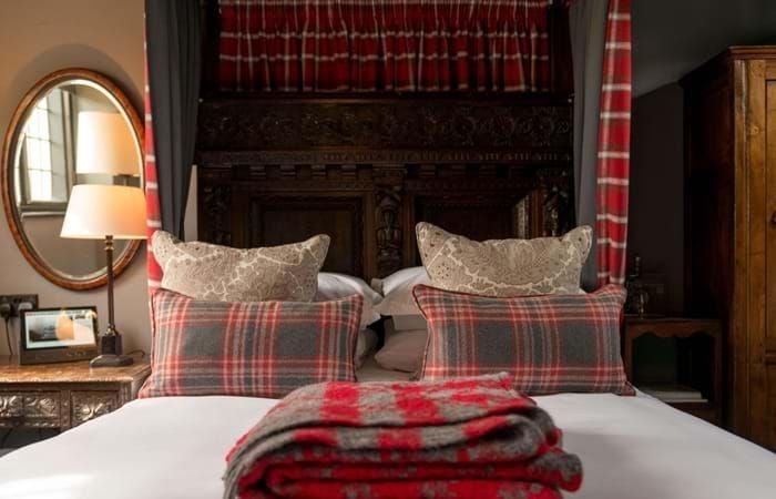 Elegant single room with classic British decor, soft neutral tones, plush bedding, and traditional wooden furniture in a historic boutique hotel setting