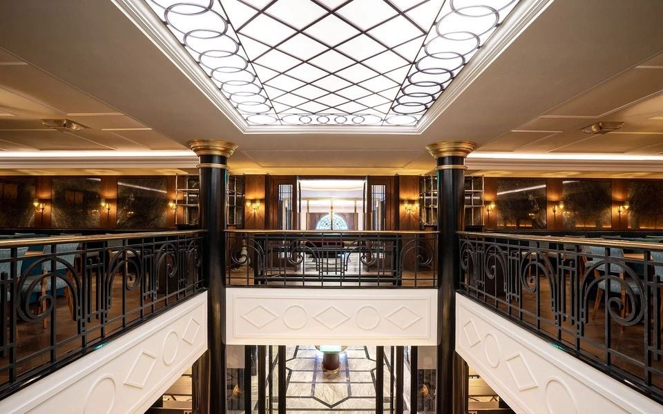 Luxurious Art Nouveau facade of historic hotel in Porto, featuring ornate golden details, elegant architectural design, and grand entrance with classic Portuguese styling.