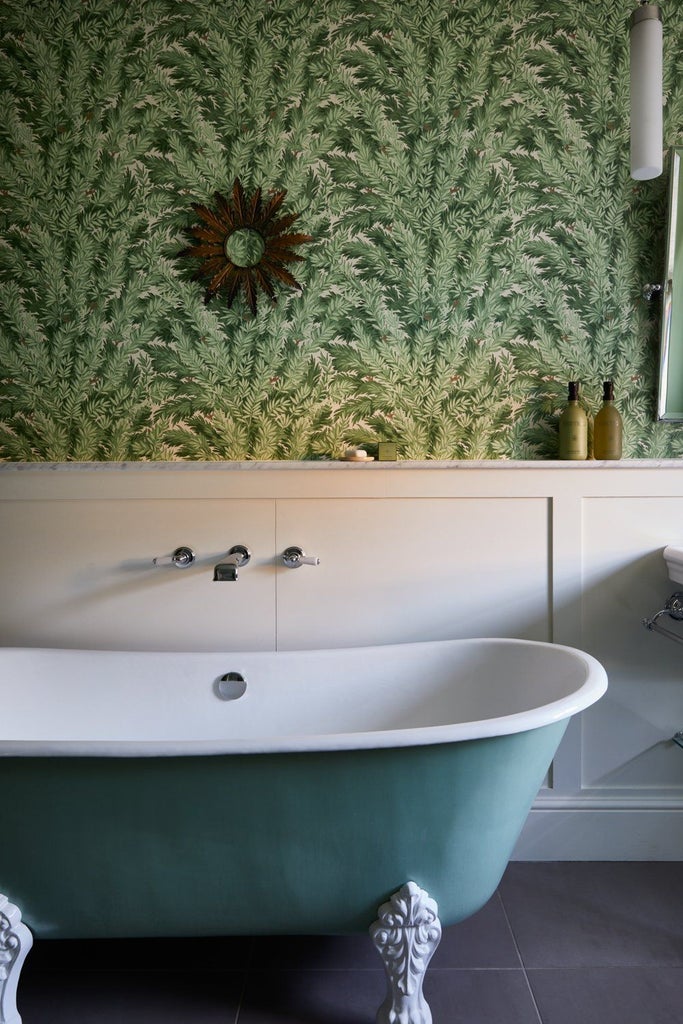 Luxurious hotel bedroom with plush white bedding, elegant wooden furnishings, soft neutral color palette, and refined botanical-inspired decor in a UK boutique hotel room