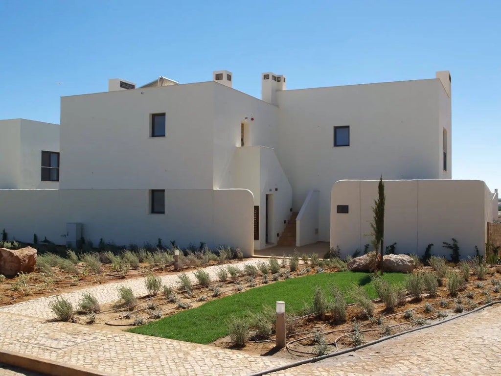 Luxurious garden house at Martinhal Sagres Beach Resort, featuring modern design, green landscape, and seamless indoor-outdoor living in coastal Portugal