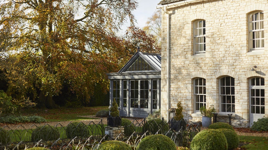 Elegant stone Georgian country house hotel with manicured gardens, classic architectural details, and refined countryside charm in rural United Kingdom setting.