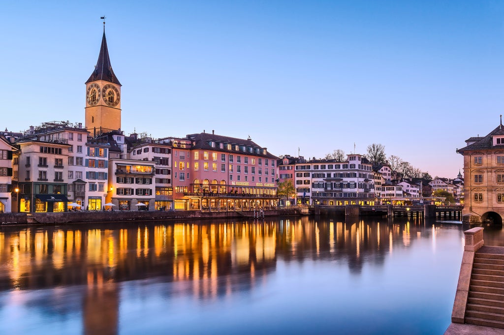 Elegant white boat cruising Lake Zurich, framed by Swiss Alps, showcasing pristine urban waterfront and luxurious scenic landscape at midday