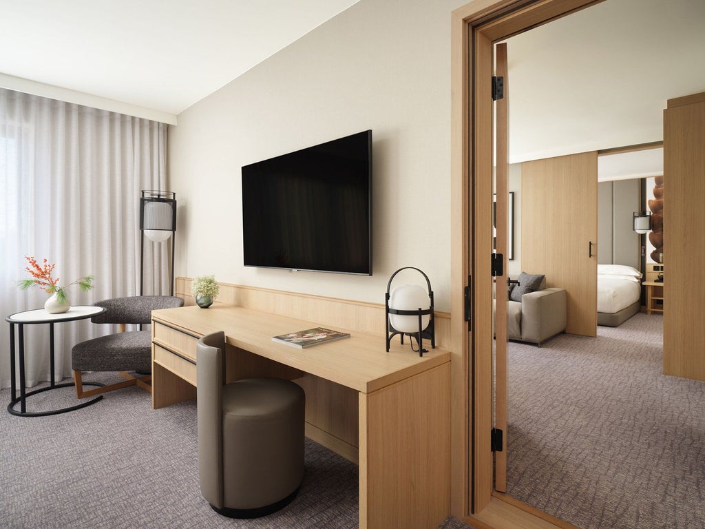 Elegant modern hotel room with sleek minimalist design, soft neutral tones, luxurious bed, contemporary furnishings at Nobu Hotel London Portman Square.