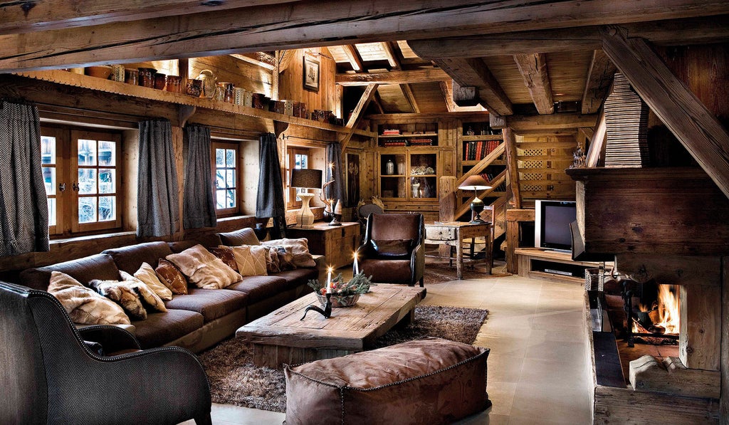 Luxurious French alpine chalet hotel with wooden balconies, stone facade, and snow-covered pine trees in a mountain setting at dusk