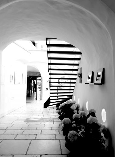 Historic boutique hotel with elegant white facade, black wrought-iron signs, and traditional Austrian architecture in Salzburg's old town