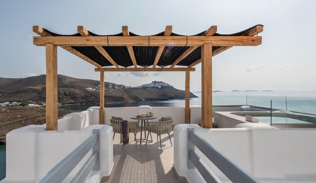 Elegant whitewashed Greek island suite with blue-domed roof, overlooking Aegean Sea, luxurious balcony with traditional Cycladic architectural details and stunning azure waters