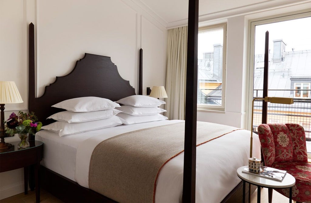 Elegant Scandinavian-style standard double room with plush white bedding, warm wood accents, and soft neutral tones at Hotel Villa Dagmar in Sweden