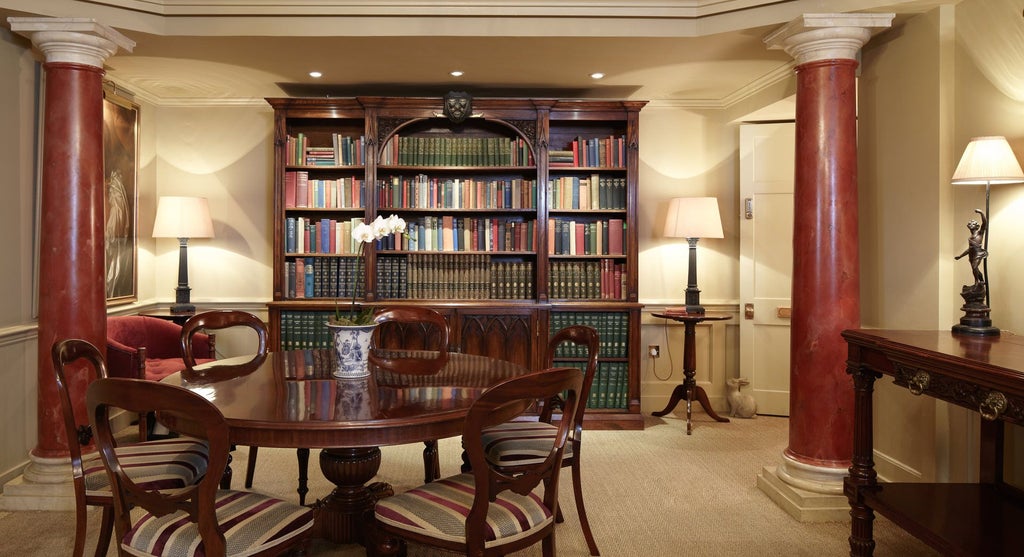 Historic boutique hotel facade in United Kingdom, elegant Georgian townhouse with ornate windows, refined black exterior, luxurious architectural details in central London location