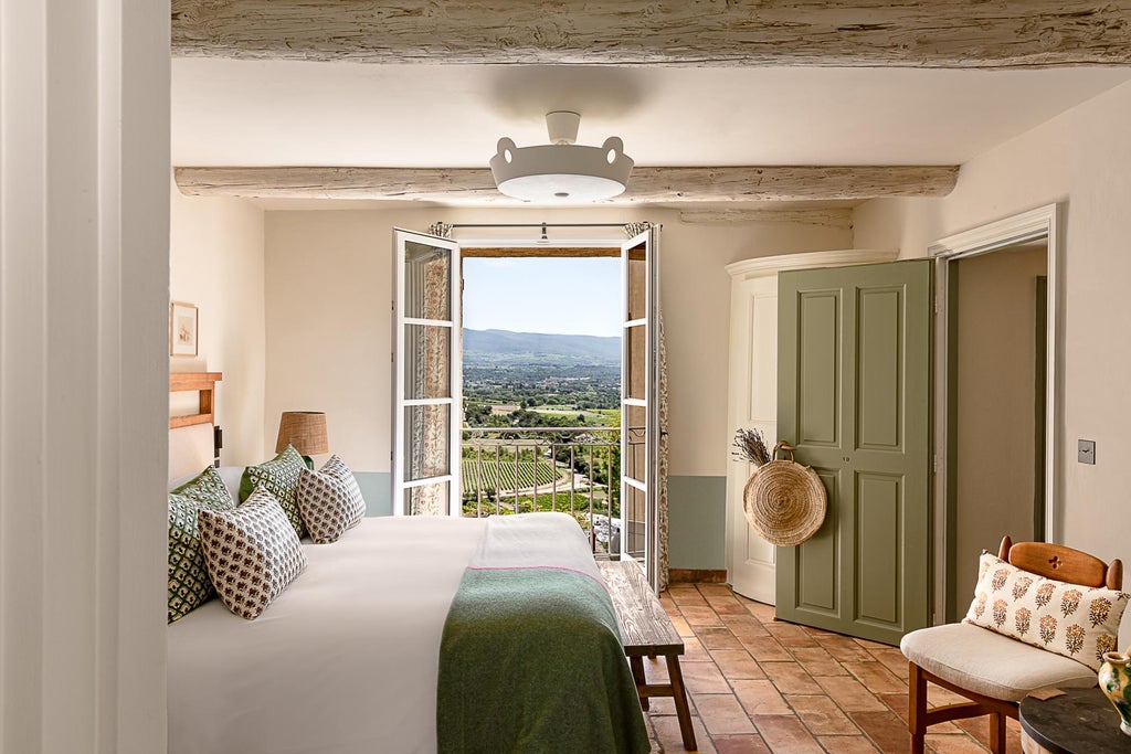 Luxury French hotel Crillon Le Brave perched on hillside, stone walls and terracotta roofs blend with lush gardens and mountain views