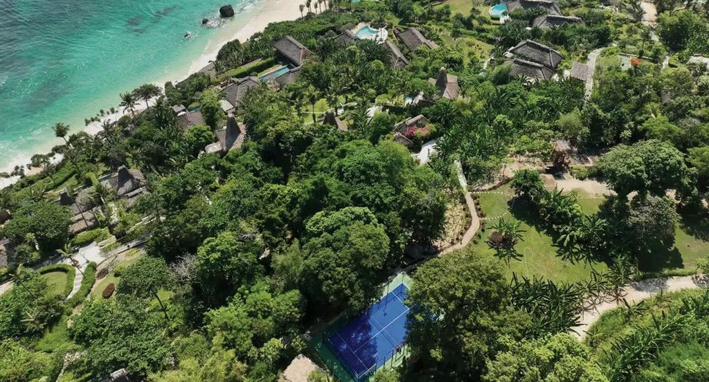 Luxurious open-air jungle villa at NIHI Sumba resort, featuring traditional Indonesian design with panoramic tropical forest views and private infinity pool