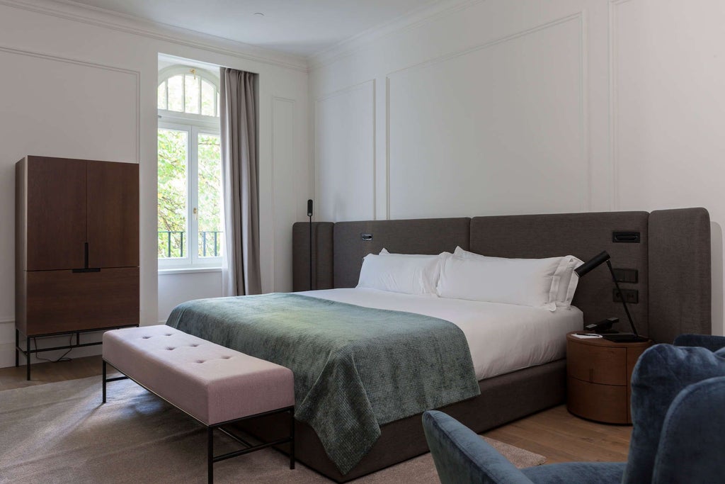 Elegant superior room with modern decor, plush white bedding, sleek dark wood furnishings, and expansive city view at scenset Hotel Suites & Spa in Hungary