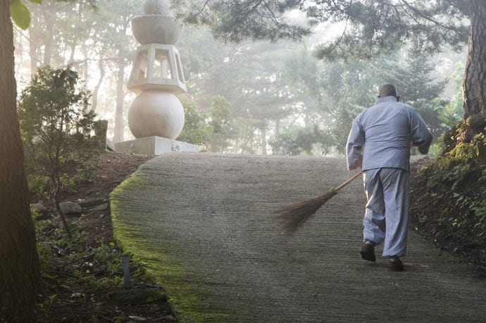 A monk sweeps the path at Golgusa Temple